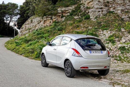 Lancia Ypsilon 3rd generation mini hatchback in hills at Erice, Sicily