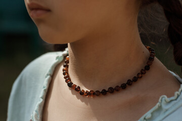 Amber beads close-up on the girl's neck