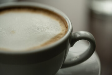 Top view white cup of hot coffee latte on wood background in restaurant.Top view with copyspace for your text.