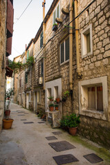 Fototapeta na wymiar A residential street in the historic coastal village of Kastel Gomilica in Kastela, Croatia