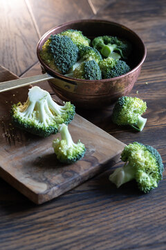 Broccoli cabage cutted on wooden board and put to colander