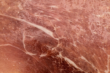 Thin slices of prosciutto crudo, uncooked dry cured ham, italian speciality
