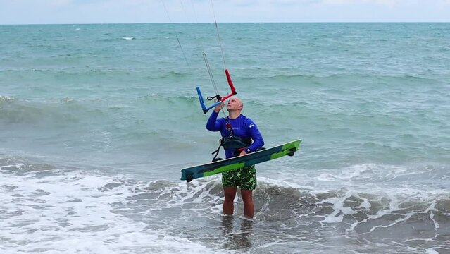 Man kite surfer entering the sea before the ride in Vietnam kite spot