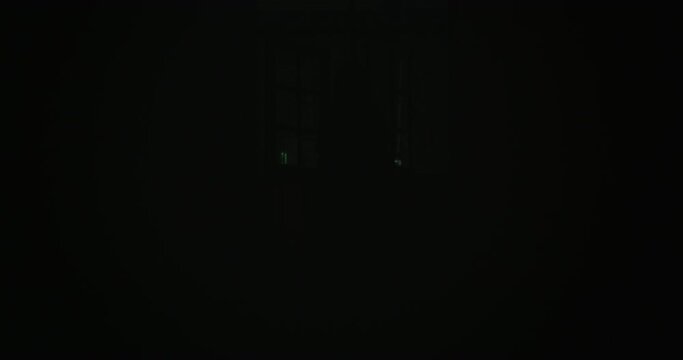 Horror scene of a mysterious Scary Asian ghost woman creepy have hair covering the face walking to camera with Flickering Lights at abandoned house with dark scene movie at night, festival Halloween 