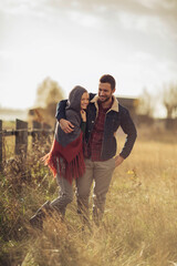 Young couple walking on a field in the countryside