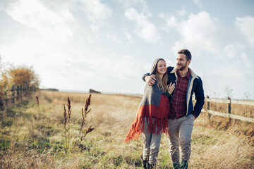 Young couple walking on a field in the countryside