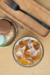 Iced latte coffee in glass on cafe table background top view. Summer fresh coffe drink