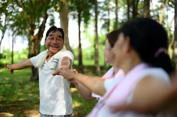 Daughter Take Care of Senior Parent for Heartwarming Exercise in Green Public Park, Senior Parent Exercise and Bonding Moments with Daughter, Health Care in Retirement or Old Age.