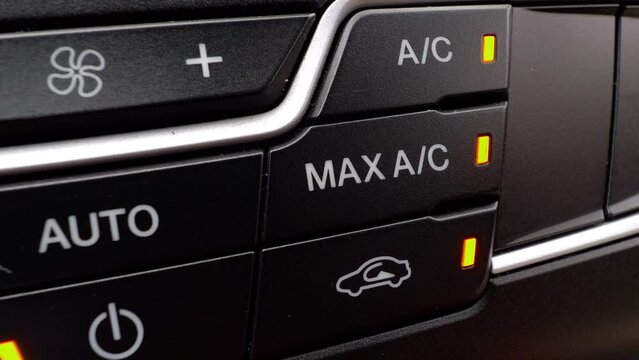 Switch off a car air conditioner. Driver press AC button on a automobile dashboard.
