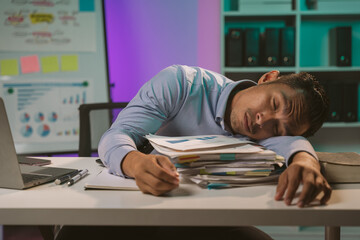 Young Asian businessman talking on the phone
late night hustle ambitious Working overtime talking...