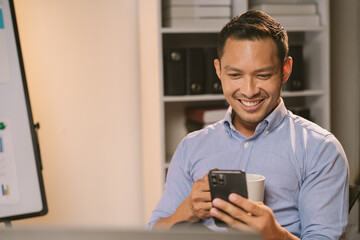 Young Asian businessman talking on the phone
late night hustle ambitious Working overtime talking on the phone in the organization