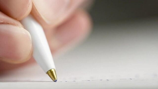 write with a ballpoint pen on paper extremely close-up