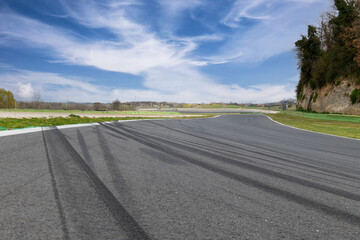 Road asphalt track with skid marks, low angle view of motor sport racetrack