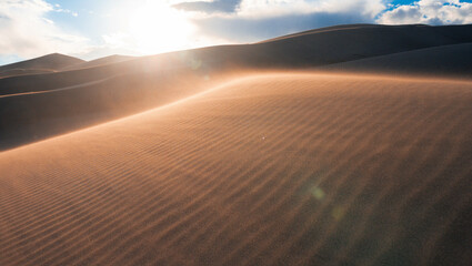 Fototapeta na wymiar desert with cloudy sky during sunset