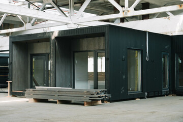 A new wooden modular prefabricated house inside an industrial building