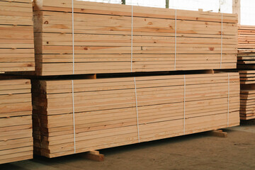Lumber in a large warehouse. Wooden boards in the stack