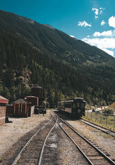 Wild West train between mountains at noon