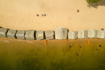 Aerial view of palm-thatched beach huts at Pindobal, a freshwater beach on the banks of the Tapajos...