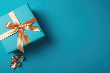 Gift box with satin ribbon and bow on blue background