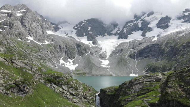 Drone flying backward from Katora Lake, located in Pakistan's KPK Province. It's a popular tourist and trekking destination. 