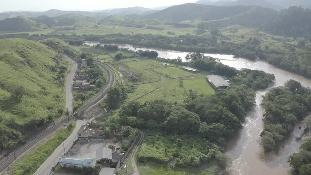 Sunset over the Para&iacute;ba do Sul river, with its brown waters and woodland on the banks. The river is the main source of water supply for the state of Rio de Janeiro.
