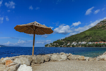 Sunshade straw umbrella on the beach

