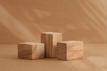 Wooden eco rustic platform podium on beige. Minimal empty display product presentation scene. Lght and shadow background.