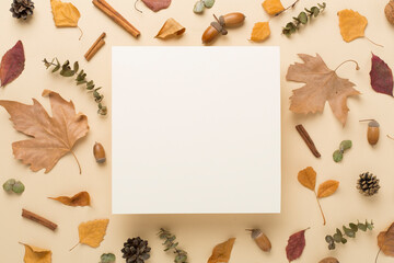 Greeting card mockup with autumn leaves on color background, top view