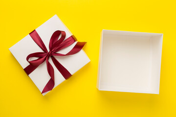 Open gift box on color background, top view. Mock up for design