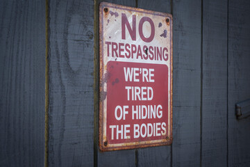 no trespassing sign on a wooden door