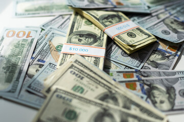 A pile of hundred dollar bills stacked on a white background with a clipping path