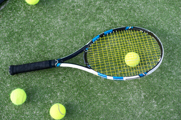 Tennis Racquet with Ball over Green Artificial Grass. Vertical Image