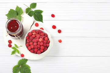 Village harvest, jars of raspberry jam on light wooden background with leaves, shop banner and advertisement, healthy natural food concept, breakfast with ingredients, home canning concept,