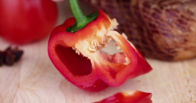 red sweet pepper on the kitchen board, cooking a dish using red ripe pepper