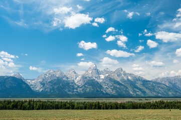 Grand Teton Range Stands In Contrast Over The Flat Fields Below