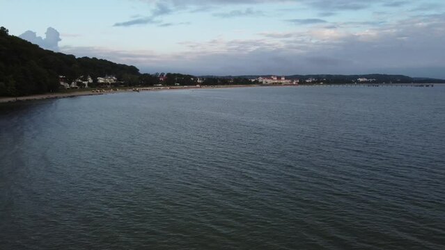 Aerial drone view - Binz shortly after sunrise, the Kurhaus Binz, pier, Ruegen Germany, Europe