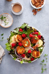 Fried goat cheese salad with apples and raspberries and vinaigrette dressing