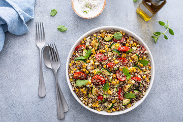 Warm quinoa salad with tomatoes, corn and zucchini