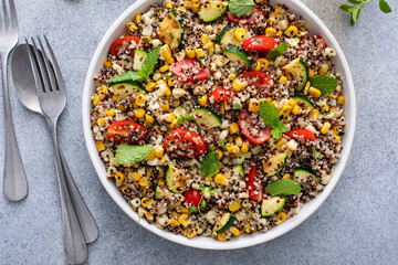 Warm quinoa salad with tomatoes, corn and zucchini