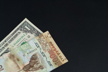 One US dollar and one hundred Russian rubles. Exchange rate. An image with a shallow depth of field.