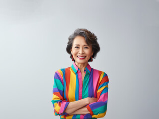 Portrait of a Smiling Asian Business Woman middle age 50s 40s arms crossed isolated white background