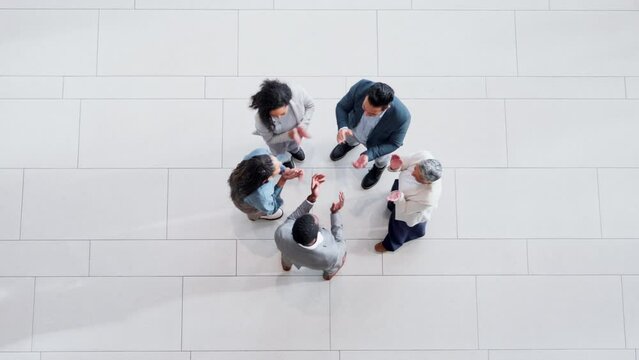 Above, motivation and hands of business people with applause as team building, teamwork and support together as group. Collaboration, huddle or circle of success by winning employees in celebration