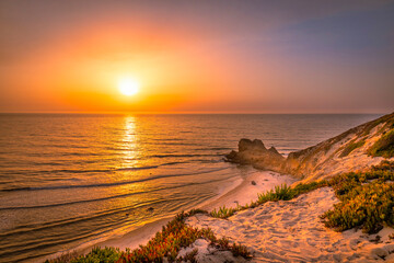 Beautiful sunset at the beach. Sunset at the portuguese beach of Paredes Vit&oacute;ria - Nazar&eacute; - Portugal