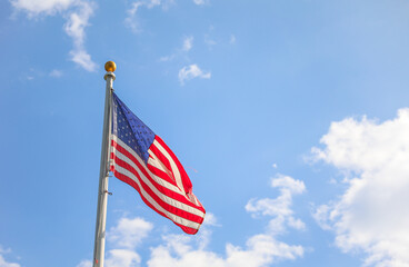 US flag waves proudly, embodying American patriotism and honor on this special holiday, symbolizing unity and freedom