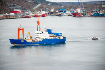Fototapeta premium St. John's, Newfoundland, Canada- OceanGate-May 29, 2023: Polar Prince towing OceanGate Expeditions submersible vessels on a barge as it leaves for the Titanic wreck site to tour below the ocean.