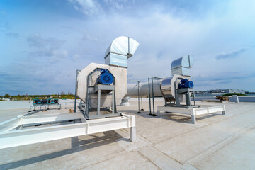 The air conditioning and ventilation system of industrial building on the roof - Powered by Adobe