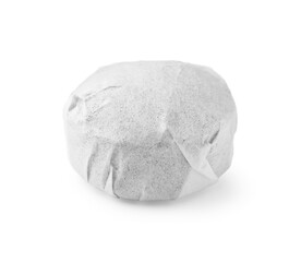 Cake shaped traditional Chinese pu-erh tea in paper wrap isolated on white