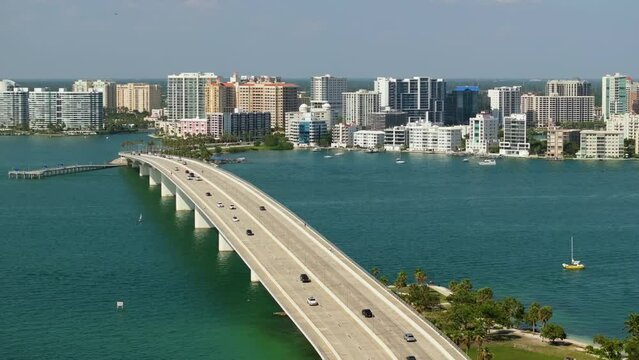 Development of housing and transportation in the US. Above view of Sarasota city, Florida with waterfront office highrise buildings and John Ringling Causeway leading from downtown to St. Armands Key