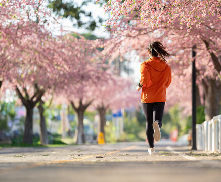 Asian woman exercise in the morning She is running at Sakura Park.