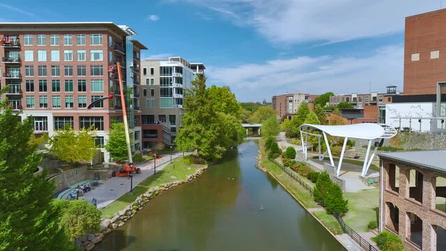 Downtown architecture of Greenville city in South Carolina. View of the Reedy River and apartment buildings. American travel destination